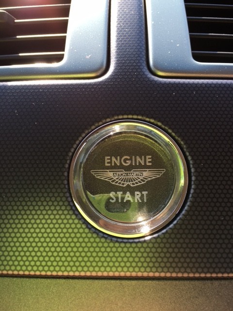 close up of silver Aston Martin V8 Vantage (2006) engine start button at topcats racing workshop