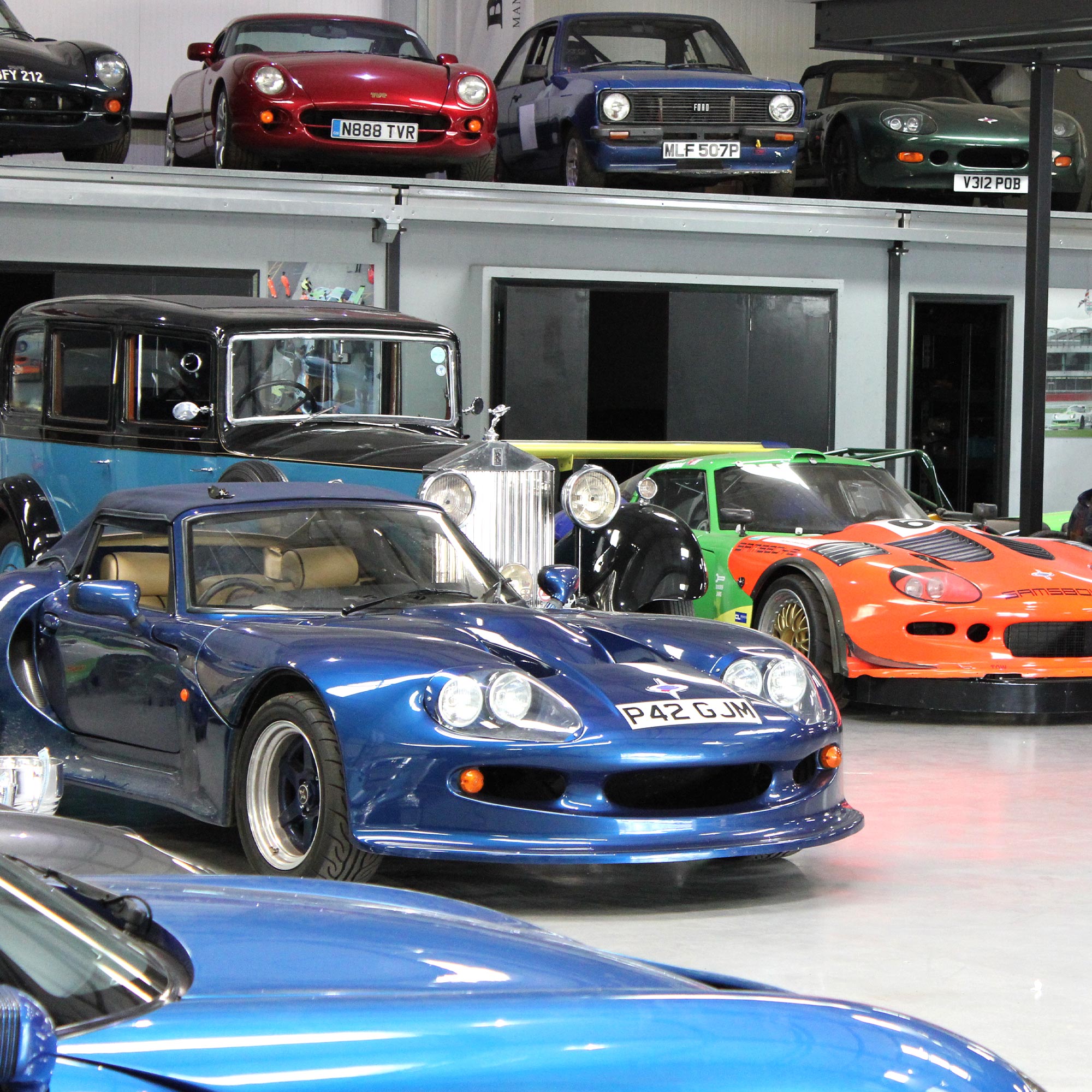 variety of performance and antique luxury cars housed at topcats racing workshop